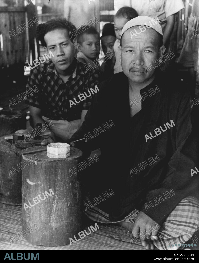 The River Kampong: Malay master-craftsman, head of the Brunei silversmiths. Malays build their houses on stilts, a simple and straightforward hut. In the whole of Malaysia you can tell a Malay house from a Chinese or an Indian one by its stilts. True the Sakai in Malaya and the Iban tribes of Borneo put their houses off the ground but they are different again. In Brunei town the Malays have gone one better, they have built their town in a river. Ten thousand men, women and children are born, live and die, eat and sleep over the water. The men are fishermen, and as fishermen the men and boys see something of the rest of the world; but the women are in a sense prisoners, doubly imprisoned by religious convention and the water of the Brunei river. May 01, 1950. (Photo by British Official Photograph).