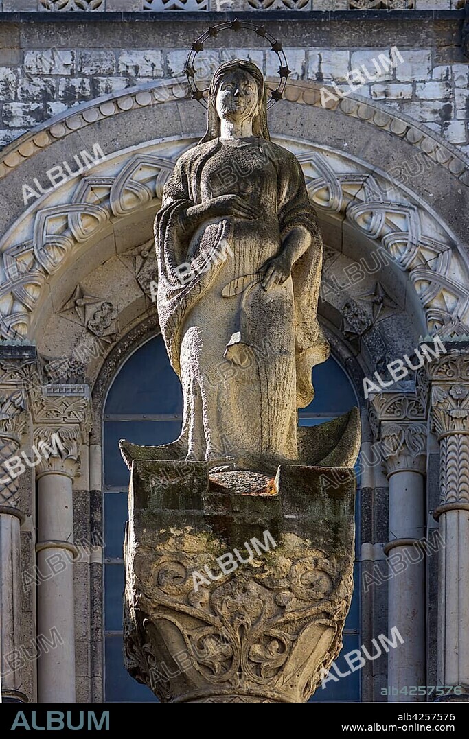 Sculpture of a saint in front of the St. Marien Liebfrauen Church, built in neo-Romanesque style 1904-1906, Berlin, Germany