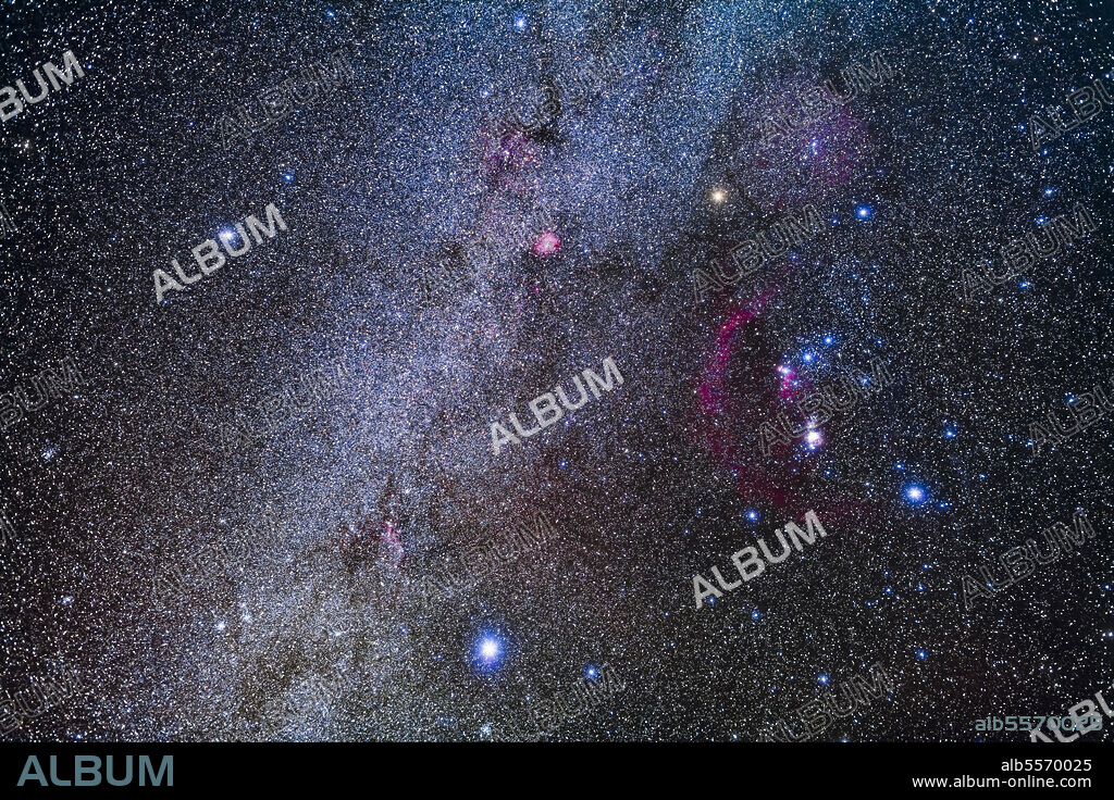 The constellation of Orion the Hunter, at right, and his two Hunting Dogs and their brightest stars: Procyon in Canis Minor (at left) and Sirius in Canis Major (at bottom).. The winter Milky Way runs from top to bottom through Monoceros and Canis Major.. The red arc is Barnards Loop, an interstellar bubble blown by hot stellar winds from young stars in the Orion complex. The red patch at upper centre is the Rosette Nebula in Monoceros. The Orion Nebula is overexposed right of centre.