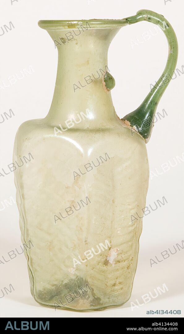 Jug. Byzantine; Eastern Mediterranean, probably Syria. Date: 501 AD-600 AD. Dimensions: 14.3 × 7.9 × 6.8 cm (5 5/8 × 3 1/8 × 2 5/8 in.). Glass, mold-blown technique. Origin: Syria.