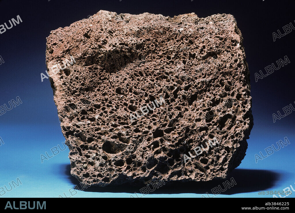 Volcanic activity causes magma (molten rock) to be violently ejected at the earth's surface. If magma cools slowly, as in a lava flow, a dense rock known as basalt may be the result; if cooling is extremely rapid, a volcanic glass such as obsidian may result. Gas bubbles trapped in magma are released in the same way as the carbonation in soft drinks when a container is opened. An extreme example of this is scoria, a dark rock created by the rapid cooling of basaltic magma that is filled with expanding gas bubbles.