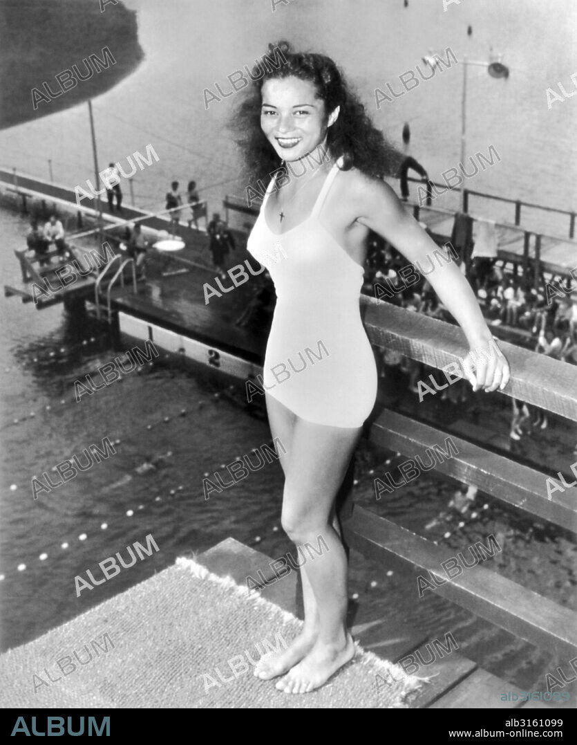 Shakamak Sate Park, Indiana:  August 16, 1946 San Francisco native Vicki Manalo Draves waits her turn in the high platform diving event in the National A.A.U. women's competition. She won the junior women's three meter competition, and went on to win gold medals for the United States in both platform and springboard diving in the 1948 Summer Olympics in London.