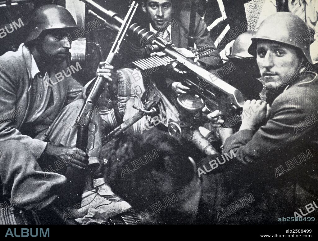 Republican fighters shelter behind a barricade during the Spanish civil war 1937.