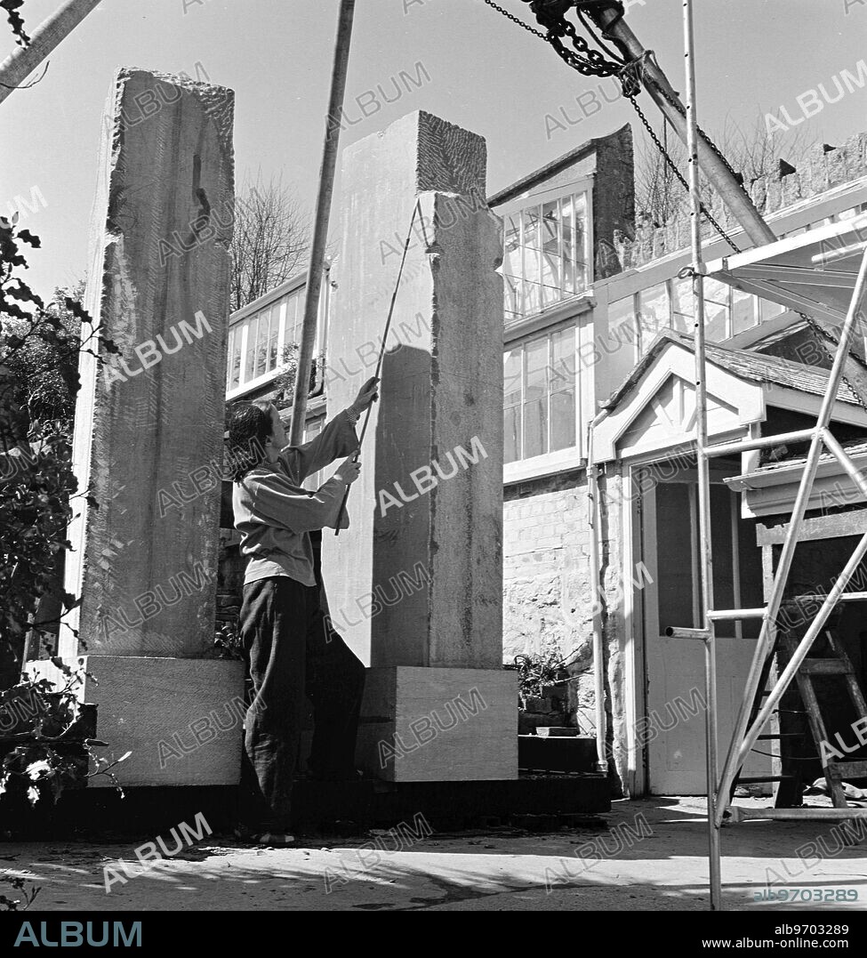 Previously unseen - Barbara Hepworth photographed by Peter Keen of Pictorial Press in 1950. Artist and sculptor Barbara Hepworth outside working on a sculpture, believed to be for the Festival of Britain Contrapuntal Forms (1951) - Artist copyright: Barbara Hepworth © Bowness - made from Irish blue limestone. 1950 Barbara Hepworth - her studio and garden. She purchased the site in 1949 and lived and worked there for 26 years until her death in a fire on the premises in 1975. Barnoon Hill, St Ives.