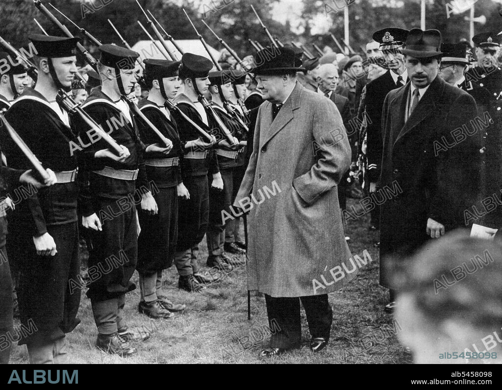 Winston Churchill Opens Woodford Victory Celebrations - Mr. Winston Churchill inspecting naval cadets at Woodford Green on his arrival tom open the celebrations.Mr. Winston Churchill, accompanied by Mrs. Churchill, opened the Woodford, Essex, victory celebrations, on Woodford Green. Woodford is Mr. Chuchill's Parliamentary constituency. June 01, 1946.