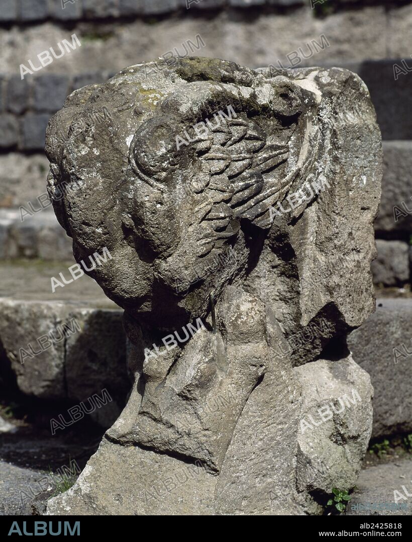 Italy. Pompeii. Ancient Roman city destroyed by the eruption of the Vesuvius in 79 AD.  Small Theatre or Odeon, built in 80 BC. Remains of a balustrade with a winged gryphon (lion's paw). Area of Ima cavea reserved to decurions. Campania.