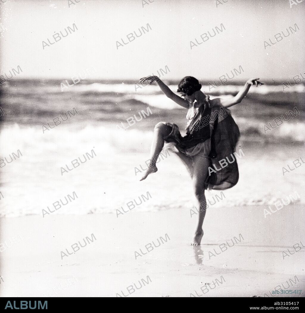 Photograph of Anna Denzler, a member of the Isadorables who danced under the instruction of Angela Isadora Duncan (1877-1927) American dancer who lived in Western Europe and the Soviet Union until her death. Photographed by Arnold Genthe (1869-1942) German-born, American photographer. Dated 1921.