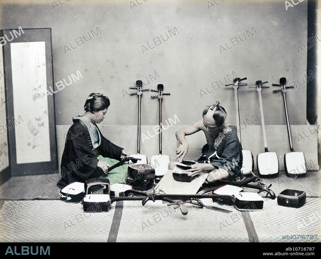[ 1870s Japan - Japanese Shamisen Craftsman ] A craftsman working on a shamisen, a three-stringed musical instrument played with a plectrum called a bachi. 19th century vintage albumen photograph.