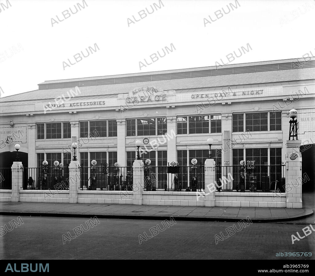 Bluebird Garage, King's Road, Chelsea, London, 1927. Built in 1924 for the Bluebird Garage Company, whose logo appears on the gatepiers and petrol pumps. The exterior carries contemporary Art Deco detailing in faience over concrete and steel.