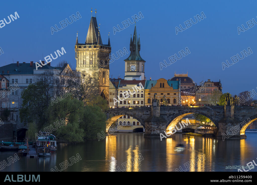 View over Charles Bridge, Old Town Bridge Tower and Vltava River at dusk, UNESCO World Heritage Site, Prague, Bohemia, Czech Republic, Europe.