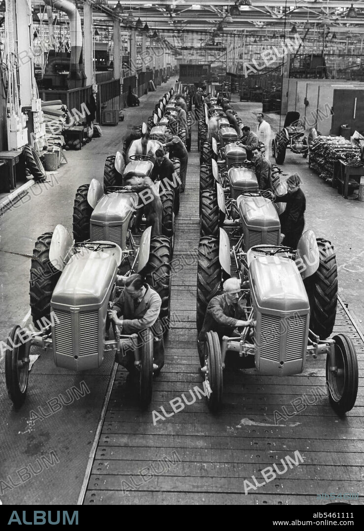 America Importing British-Made Ferguson Tractors £15,000,000 Order -- A double row of nearly-completed Ferguson tractors on the assembly line at the Coventry factory. In the world's largest tractor factory here, 250 tractors leave the production lines every day as part of a £15,000,000 order for America, one of the greatest manufacturers of these machines. First batch of this order - a vital part of Britain's export drive - will sail in the freighter 'American Farmer', recently salvaged after being wrecked off the British coast when sailing here with essential parts for the tractors. January 16, 1948.