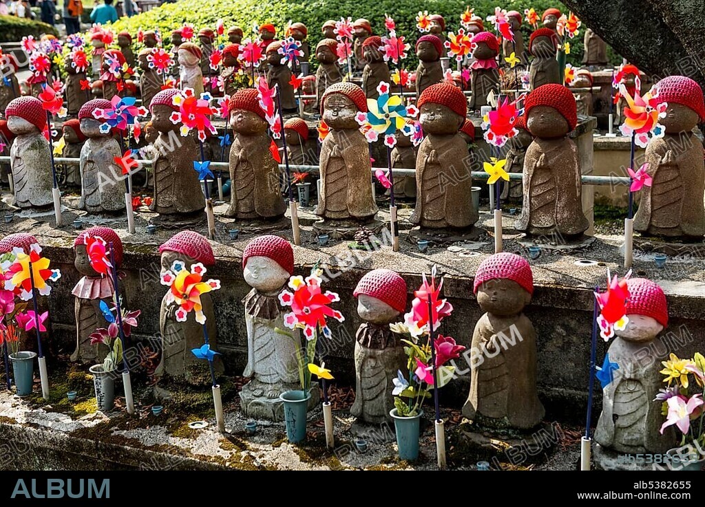 Jizo statues with red caps, protective deities for deceased children, Zōjōji Temple, Buddhist temple complex, Tokyo, Japan