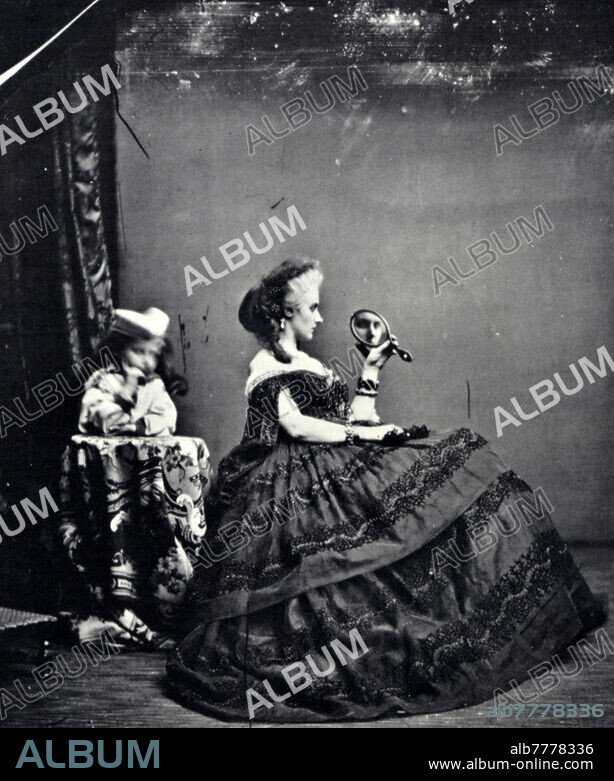 Virginia OLDOINI (22 March 1837 - 28 November 1899) called La Contessa di Castiglione, admires herself in a small mirror. Italian noblewoman and Risorgimento patriot, seductive and charming, considered one of the most beautiful women of the time. Photographic portrait executed in the Mayer et Pierson studio, France, Paris 1855-1870.