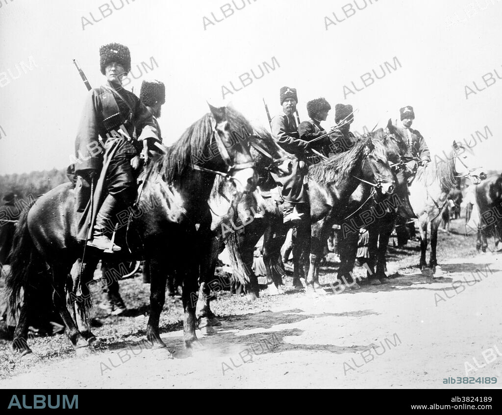 Russian cossacks during World War I. At the outbreak of World War I the mounted Cossacks made up 38 regiments, plus some infantry battalions and 52 horse artillery batteries. By 1916 their wartime strength had expanded to 160 regiments plus 176 independent sotnias (squadrons), the latter employed as detached units. While about a third of the regular Russian cavalry was dismounted in 1916 to serve as infantry, the Cossack arm remained essentially unaffected by modernization. The basic uniform consisted of the standard loose-fitting tunics and wide trousers. Some wore the very long, open fronted, cherkesska coats with ornamental cartridge loops and colored beshmets (waistcoats). These have come to epitomize the popular image of the Cossacks. Most wore fleece hats with colored cloth tops in full dress, and round caps, with or without peaks, for ordinary duties. Bain News Service circa 1914/15.