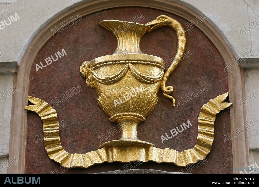 Prague, Czech Republic. Escutcheon on the facade of a building with depiction of a jug. "The Golden Jug" (U Zlate). Melantrichova Street. Old Town (Stare Mesto).