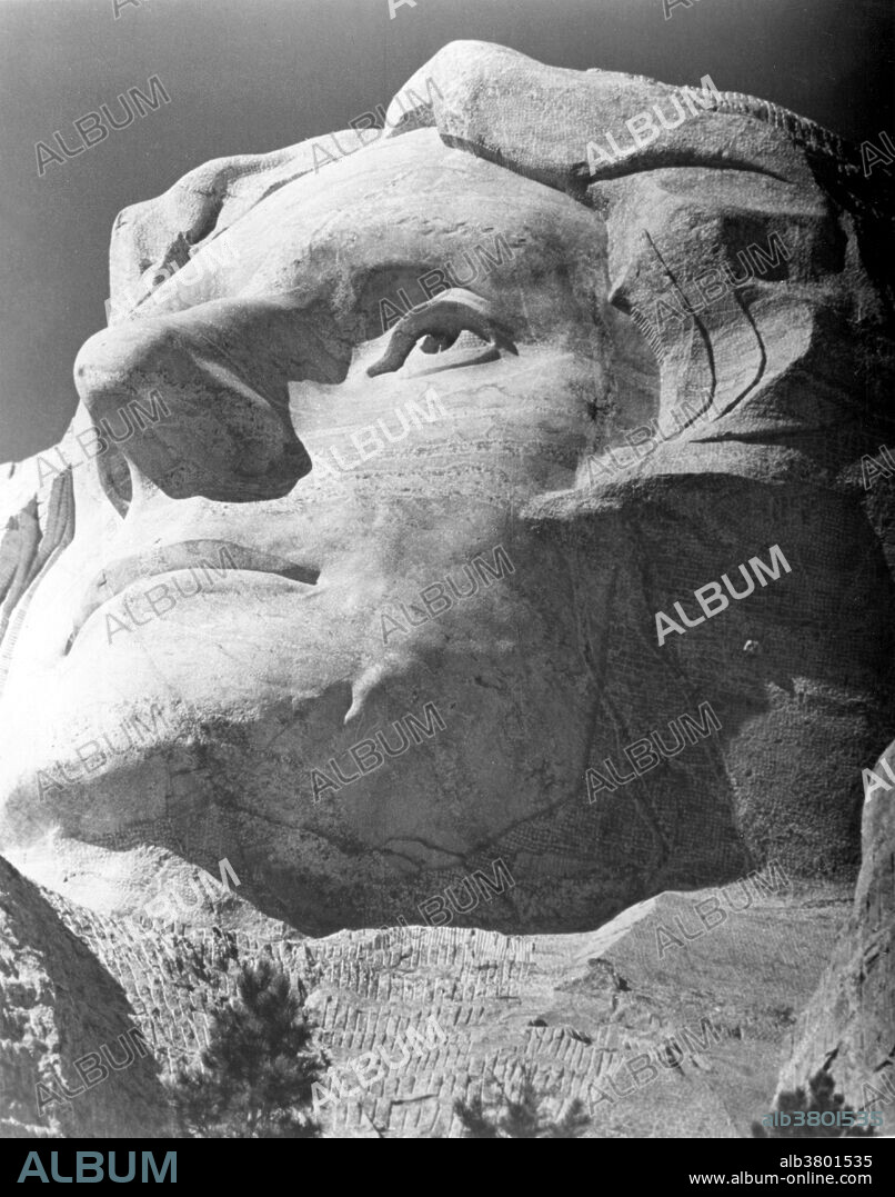 The first attempt at Thomas Jefferson on Mount Rushmore. Jefferson's head was started in 1934, to the right of Washington. Before the head was complete, Borglum requested that it should be blasted off due to poor rock quality. Jefferson's head was restarted on Washington's left. Jefferson's head was dedicated in 1936. Mount Rushmore National Memorial is a sculpture carved into the granite face of Mount Rushmore near Keystone, South Dakota. Sculpted by Danish-American Gutzon Borglum and his son, Lincoln Borglum, Mount Rushmore features 60 foot sculptures of the heads of four United States presidents: George Washington, Thomas Jefferson, Theodore Roosevelt, and Abraham Lincoln. Construction on the memorial began in 1927, and the presidents' faces were completed between 1934 and 1939. Although the initial concept called for each president to be depicted from head to waist, lack of funding forced construction to end in late October 1941. Mount Rushmore has become an iconic symbol of the United States, and attracts over three million people annually. NPS, no photographer credited, undated.