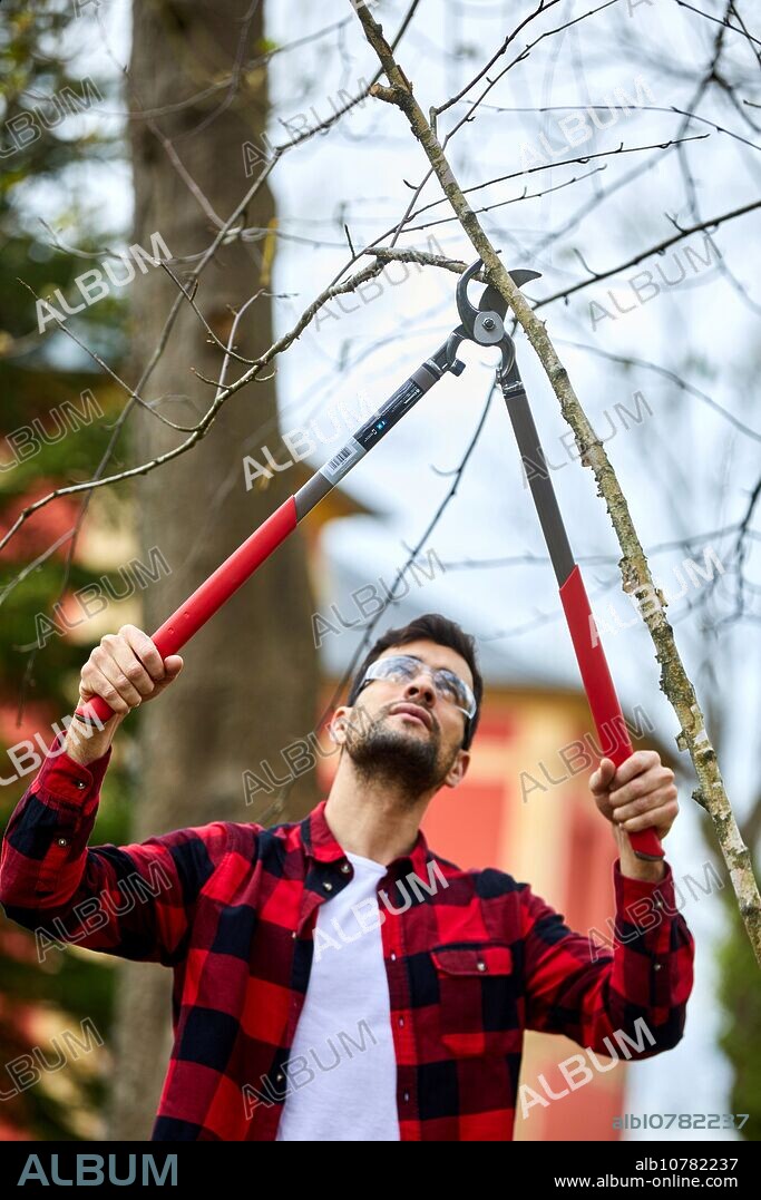 Gardener with prunning tool, Lopper, Aiete Park, Donostia, San Sebastian, Gipuzkoa, Basque Country, Spain, Europe.