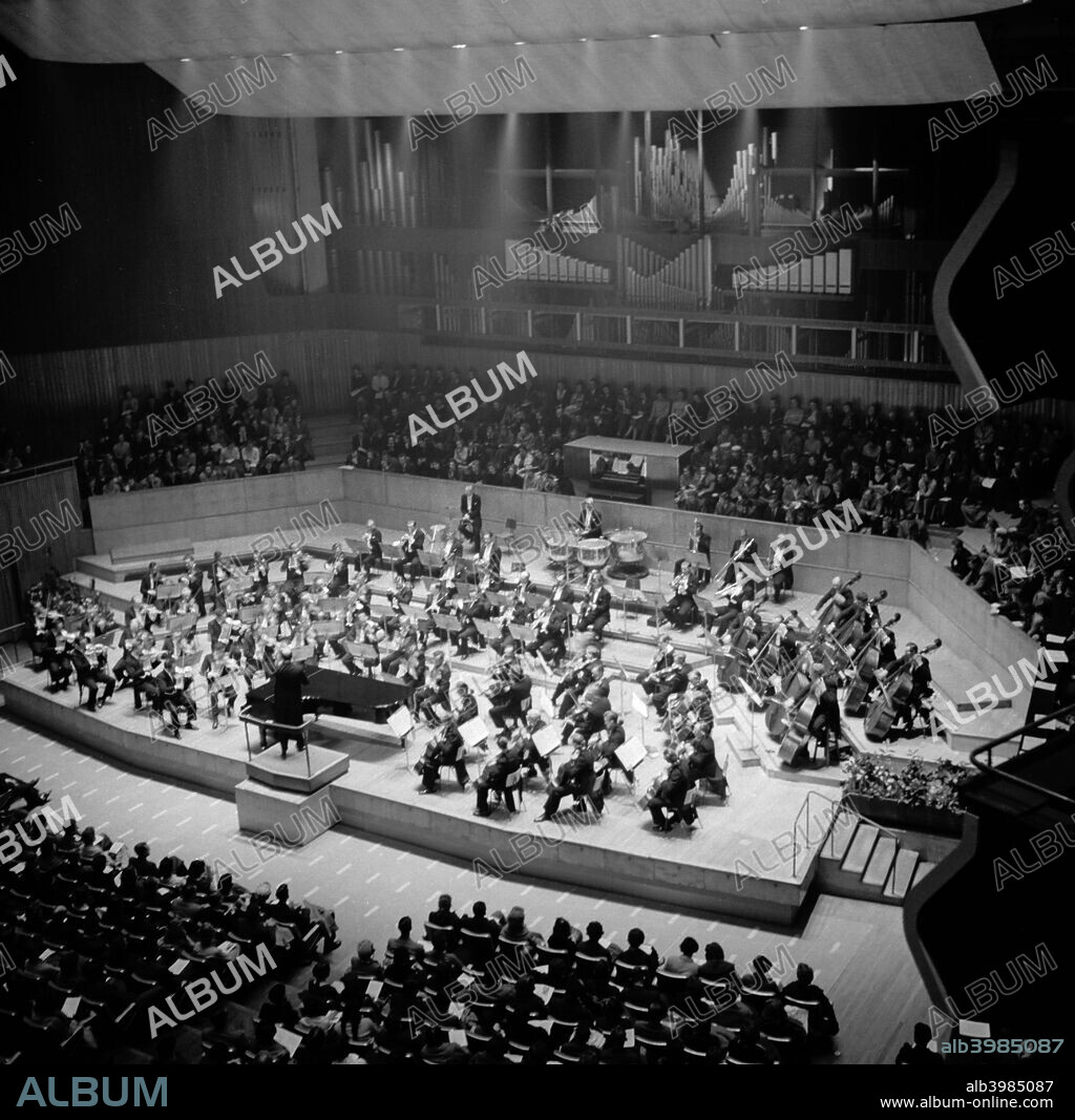 Royal Festival Hall, Belvedere Road, South Bank, Lambeth, London, c1954-1962. Interior view showing an orchestra playing to an audience. The Royal Festival Hall was designed by Sir Robert Matthew, Leslie Martin and Peter Moro. It was built in 1949-1951 as a concert hall for the Festival of Britain.
