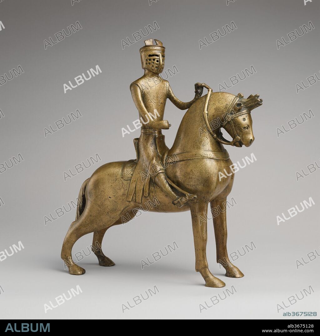Aquamanile in the Form of a Mounted Knight. Culture: German. Dimensions: Overall: 14 11/16 x 12 7/8 x 5 5/8 in. (37.3 x 32.7 x 14.3 cm)
Weight PD: 146.5oz. (4153g). Date: ca. 1250.
Aquamanilia, from the Latin words meaning "water" and "hands," served to pour water over the hands of priests before celebrating Mass and of diners at table. This aquamanile, in the form of a horse and rider, exemplifies the courtly ideals of knighthood that pervaded Western medieval culture and influenced objects intended for daily use.  It depicts a type of armor that disappeared toward the third quarter of the thirteenth century. Unfortunately, the shield--which probably displayed the arms of the owner--and the lance are no longer extant.