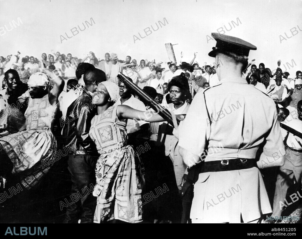 Orig. bildtext... SOUTHERN RHODESIA OUTLAWS ZAPU. The Southern Rhodesian Government today banned the Zimbabwe African People's Union (Zapu) and arrested several of its leaders. At the same time it called up army and air forces reservists to aid the civil authoritiouth. The Rhodesian Government has acted after a wave of violence and arson. On Sunday, September 16th, one African was killed, another seriously injured and several Europeans injured in battles which developed between rival African factions following a meeting of the ZAPU attended by between 7000 to 8000 Africans at Harare African Township. Political successes gained by viloence in other African countries are belived to have persuade some African nationalists in Southern Rhodesia that terrorism is now only way to achieve their objective. Schools, shops and factories had been looted and burned in this wave of violence. PHOTO SHOWS: African women lead a large crowd in an attempt to break through a police cordon at a meeting of the Zimbabwe African People's Union at Harare, Salisbury. Anm. Politisk opposition Nationalism Ryggbilder sites: HARARE ;RHODESIA ;SYDRHODESIA ;AFRIKA.