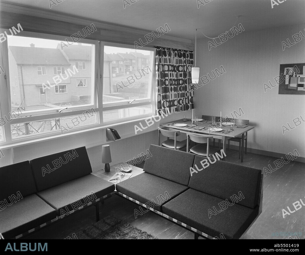 JOHN LAING PLC. Darnhill, Heywood, Rochdale, 15/07/1963. The living and dining room in the 'Sectra' show flat at Heywood. This Sectra show flat was on the first floor of a 13-storey block and was completed 13 weeks after the first Sectra formwork unit had been lifted into position. The flat was one of 51 two-bedroom and 12 bed-sitting room flats contained in each block. The flat was furnished for the occasion with Brian Amos carrying out the decor. An article on the show flat describing it as the first Sectra flat to be opened was published in August 1963 in Laing's monthly newsletter 'Team Spirit'. The exact location of the site shown has not been recorded in the negative register but it is believed to be the Darnhill Estate.