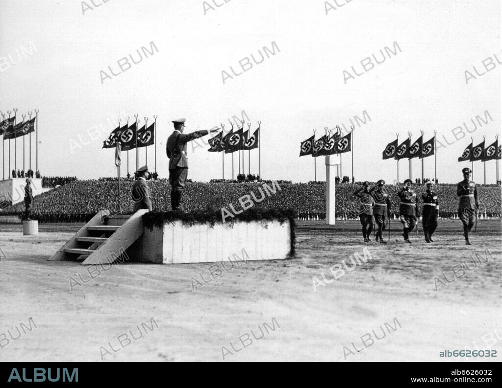 Adolf Hitler, HERMANN GÖRING, ERICH RAEDER, WERNER VON BLOMBERG und Werner Freiherr von Fritsch. On Wehrmacht Day on Nuremberg Zeppelinfeld, General Field Marshal Werner von Blomberg (r) opens the parade past Adolf Hitler (l, on the platform). Behind Blomberg (r-l): Erich Raeder, Hermann Goring, and Werner Freiherr von Fritsch. 30/11/1936