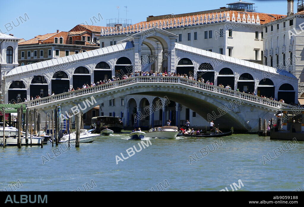 The Rialto Bridge (Ponte di Rialto), spanning the Grand Canal in Venice, Italy. It is the oldest bridge across the canal, and was the dividing line for the districts of San Marco and San Polo. The present stone bridge, a single span designed by Antonio da Ponte, was finally completed in 1591.