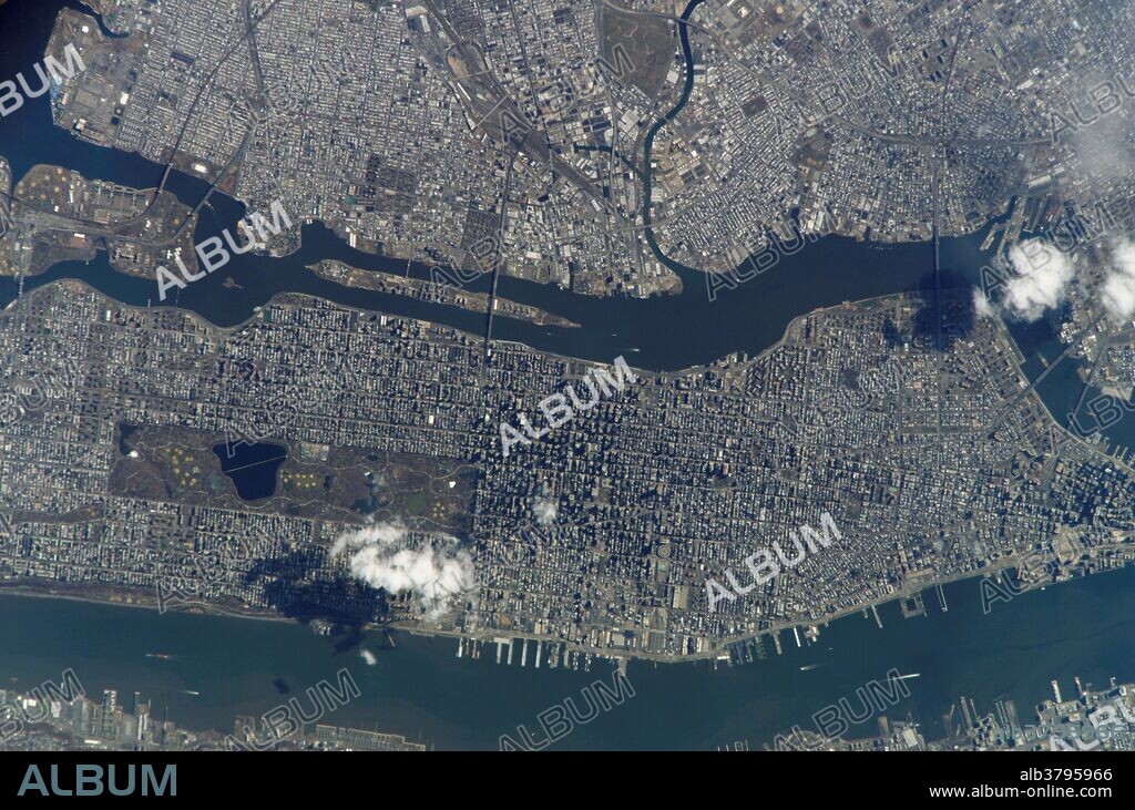 View from space of Manhattan Island. Central Park is clearly visible in the center left of the image. Some of the other New York City boroughs (including parts of Queens and Brooklyn) are also shown, as are two small sections of the New Jersey side of the Hudson River (lower left and lower right).