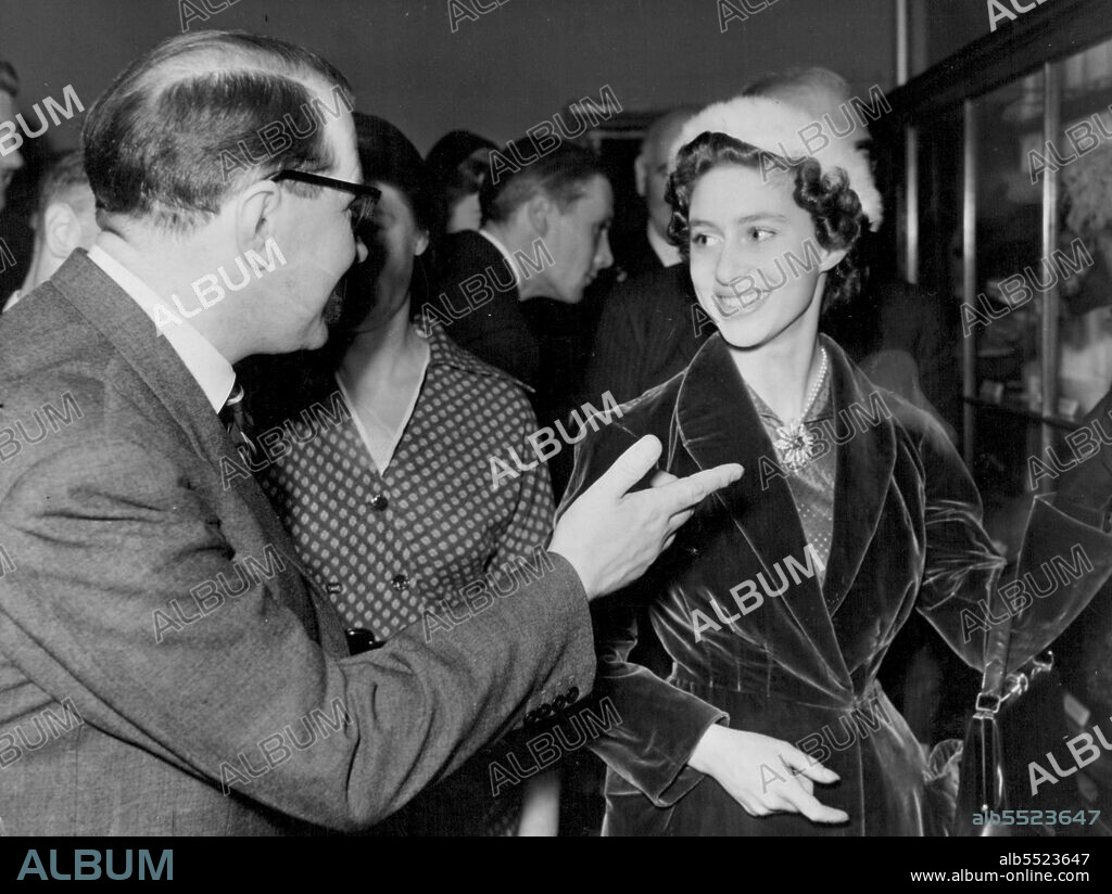 Princess Re-Opens Manchester Royal Exchange -- Hat fashions of Bygone age made Princess Margaret smile when they were shown to her by G. W. G. Fitzsimons of the Art Gallery Committee.Princess Margaret visited Manchester yesterday to officially re-open the reconstructed Royal Exchange building, which suffered extensive damage during an air raid in December, 1940. November 18, 1953. (Photo by Paul Popper, Paul Popper Ltd).