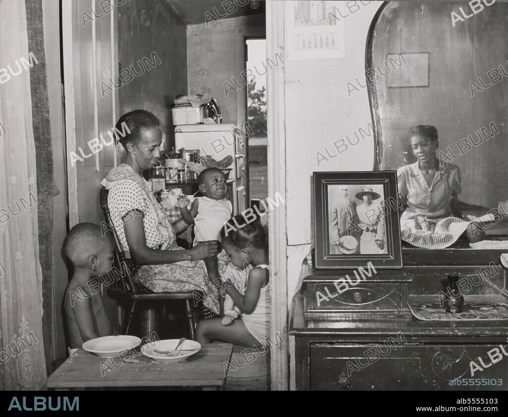 GORDON PARKS. Washington, D.C. Mrs. Ella Watson, a government charwoman, with three grandchildren and her adopted daughter.