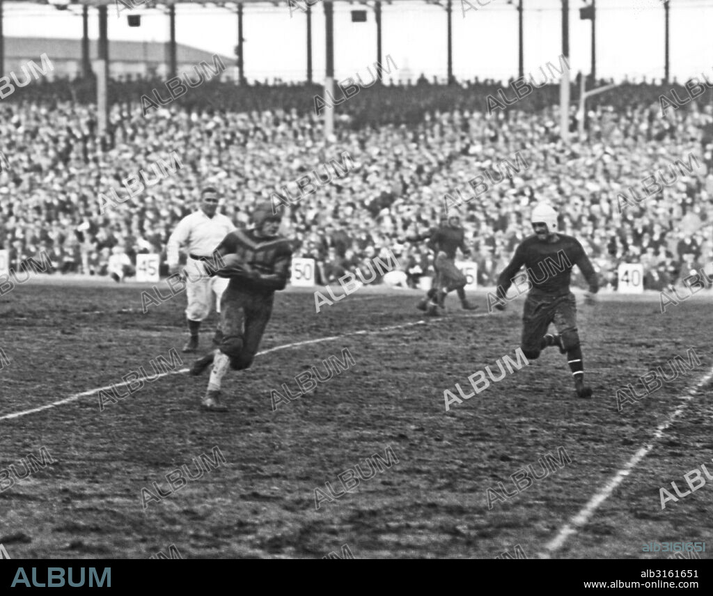 New York, New York: December 6, 1925 New pro football player Harold 'Red' Grange receiving a forward pass and making a 20 yard run. Grange made his NY debut today with the Chicago Bears playing against the New York Giants at the Polo Grounds.