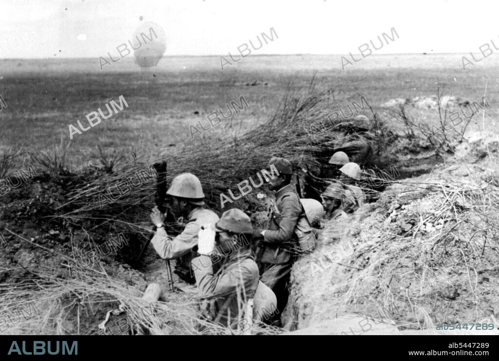 Unnamed place in Manchukuo border... Ever Watchful Westward... with larger and larger Outer Mongolian forces a massing on the western border of Manchukuo, Japanese and Manchukuo border guards are keeping a sharp lookout for frontier incursions. The terrain in the fighting area is so level, however, that the watchers must dig themselves holes in the ground and camouflage them with undergrowth from elsewhere, so they will not be too visible to possible raiders. July 04, 1939. (Photo by The Domei News Photos Service).