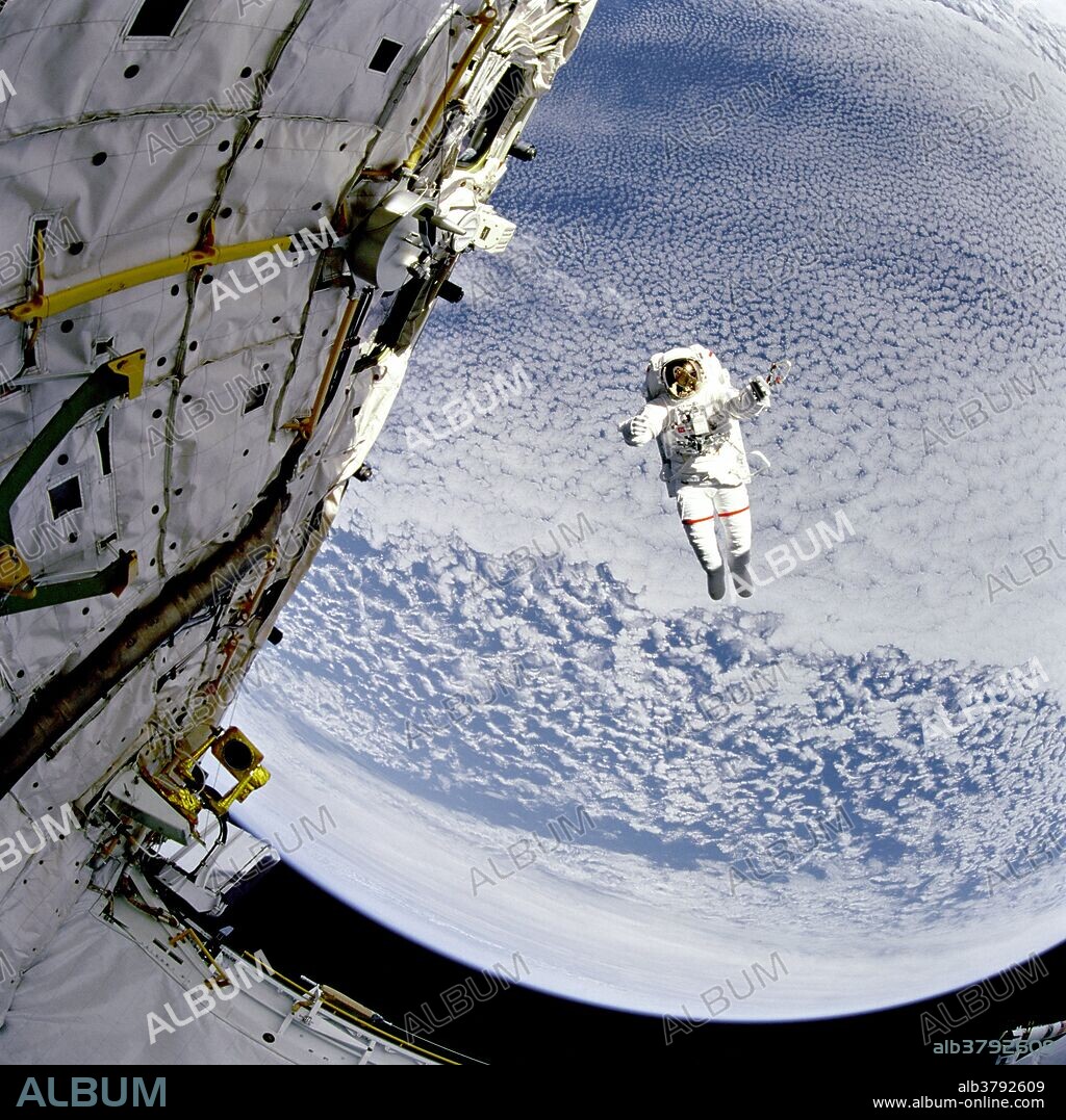 Backdropped against the blue and white Earth 130 nautical miles below, astronaut Mark C. Lee tests the new Simplified Aid for EVA Rescue (SAFER) system.