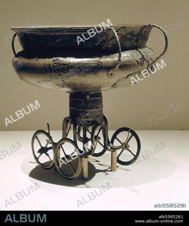 Early Bronze Age, Period III, 13th -12th century BC. Cult wagon with cauldron. Bronze, height 37.7cm, diameter of the cauldron 38cm. Found in: Peckatel, Kreis Schwerin, Mecklenburg-Vorpommern, Inv. No. BR 1146-1148. Schwerin, Landesmuseum Mecklenburg-Vorp.