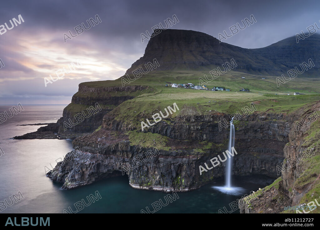Dramatic coastal scenery at Gasadalur on the island of Vagar, Faroe Islands, Denmark, Europe.
