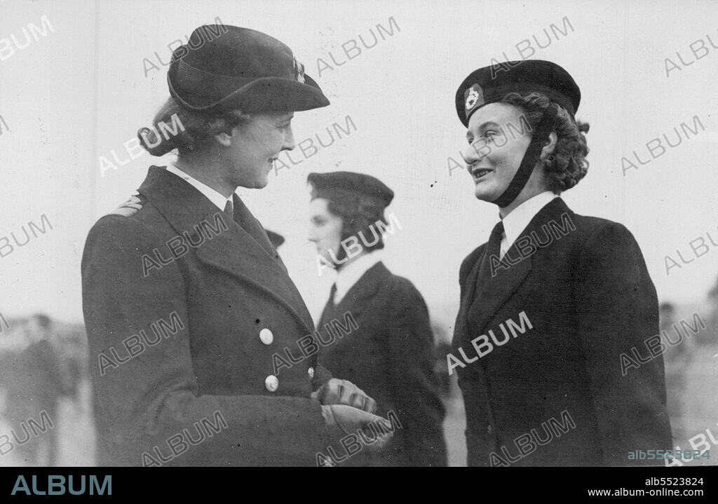 The Duchess of Kent Inspects "Front Line" Wrens -- The Duchess of Kent talking to a smiling member of the W.R.N.S. wearing the badge of the Royal Marines.The Duchess of Kent made a tour of naval establishments at Dover, where members of the W.R.N.S. have been serving in various capacities, almost continuously throughout the air raids, bombing and shell-fire which the war brought to this "front line" town. October 12, 1944.