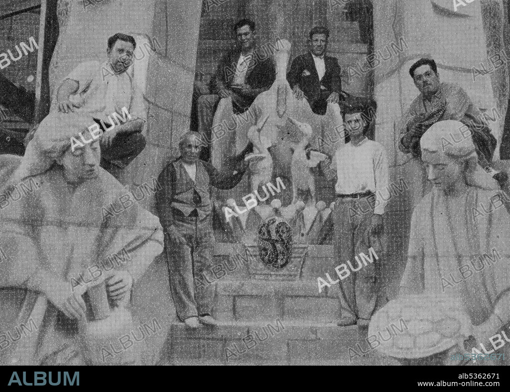 JOAN MATAMALA FLOTATS. Sagrada Familia (Nativity Facade): the sculptors pose next to the group that they made at the base of the Tree of Life of the portico of Charity, the pelican represents the Eucharist and the egg decorated with the anagram of Jesus symbolizes life and resurrection, 1932.