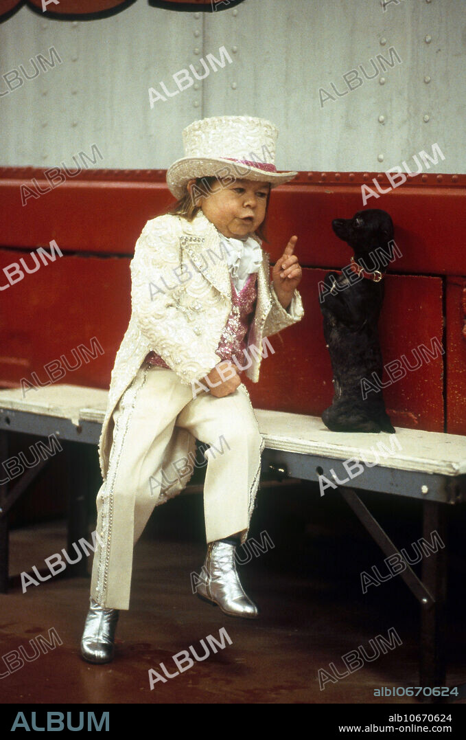 Mihaly Michu Meszaros, a Hungarian performer who is 33 inches (2 ft. 9 in.) high. He was born in 1939. Here he is working for Ringling Brothers Circus, in an act with a puppy. He is best remembered as the man behind the costume in the NBC sitcom ALF.