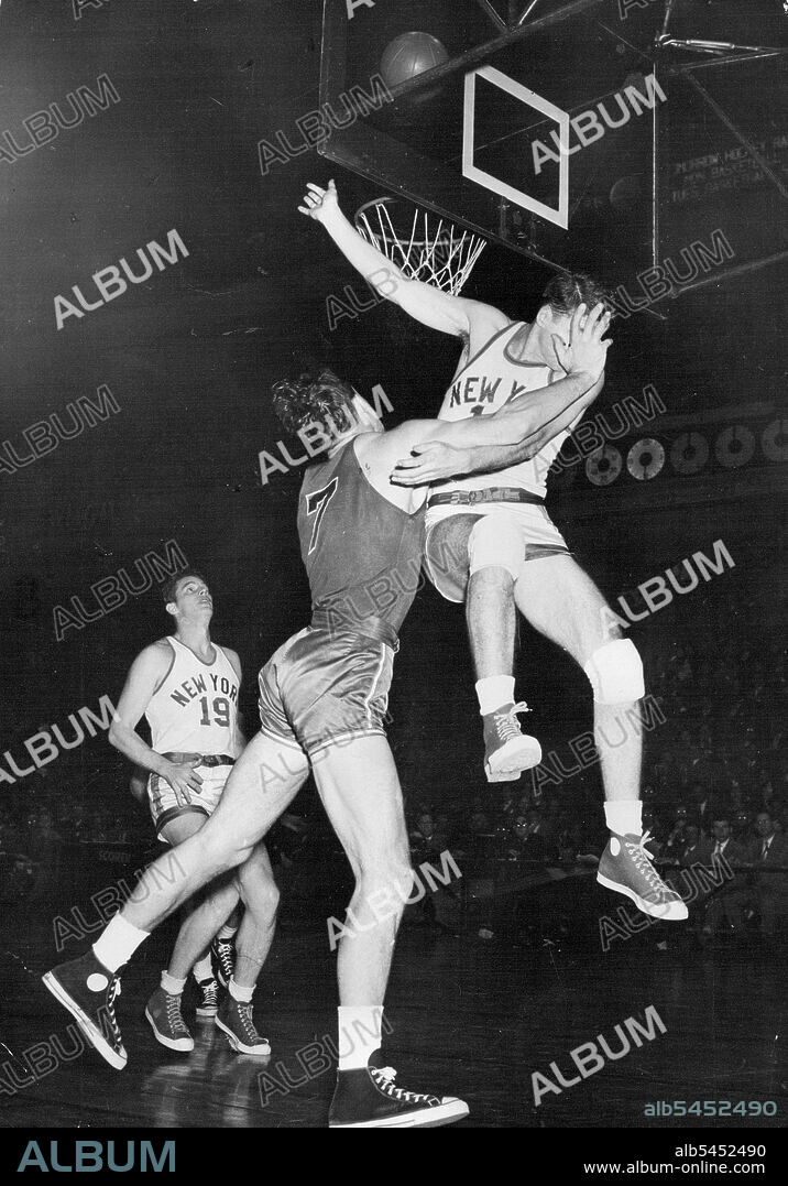 Chief "Palm In The Face"  -- John Palmer (right), New York Knickerboker forward, gets a palm in the face as he makes unsuccessful attempt to block off Stan Miasek (7), Chicago Stag reserve in second quarter of game in Madison Square Garden, New York, Dec. 25. Miasek dropped in a field goal on the play (ball over basket upper right centre.) In left background is Lee Knorek (19), Knickerboker's Centre.
There's plenty of action in top-line basketball. Here a New York player gets the worst of an exchange with a Chicago Stag forward. March 04, 1953. (Photo by AP Photo).