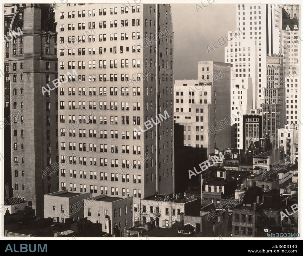 From My Window at An American Place, North. Artist: Alfred Stieglitz (American, Hoboken, New Jersey 1864-1946 New York). Dimensions: 18.9 x 24.0 cm (7 7/16 x 9 7/16 in.). Date: 1931.
In the late 1920s Stieglitz photographed New York from his apartment on the thirtieth floor of the new Shelton Hotel, and from his seventeenth-floor gallery, An American Place, at 53rd Street and Madison Avenue.  Although he had been photographing the city since the 1890s, these new spaces provided him with his first opportunity to photograph from such heights on a regular basis.  Like his extensive Portrait of Georgia O'Keeffe and his Equivalents, Stieglitz also conceived his late city views as a serial project; he produced ninety cityscapes between 1927 and 1937, when he gave up photography.  In contrast to his earlier views of New York, which were inspired by a painterly European aesthetic, the pictures from this new series are hard-edged and virtually unpopulated.  Like the gallery from which they were made, which promoted Americanness in art, these photographs of the quintessential modern American city exemplified a pure American aesthetic.