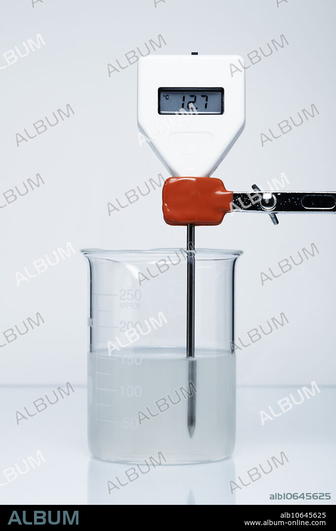 Endothermic reaction, image 2 in a series of 2. Dissolution of ammonium nitrate (NH4NO3) in water is an endothermic reaction, i.e. the energy is absorbed from the surroundings: NH4NO3 -> (NH4)+ + (NO3)-. Here 30 g of ammonium nitrate is added to a beaker with 120 mL of water, initially at 25 C (Photo 1). After ammonium nitrate is dissolved, the temperature drops to 12.7 C (Photo 2).