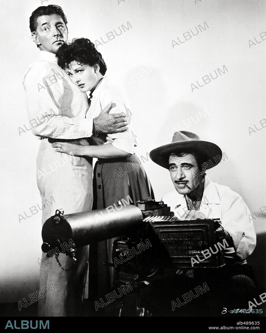 GILBERT ROLAND, ROBERT MITCHUM and URSULA THIESS in BANDIDO, 1956, directed by RICHARD FLEISCHER. Copyright UNITED ARTISTS.