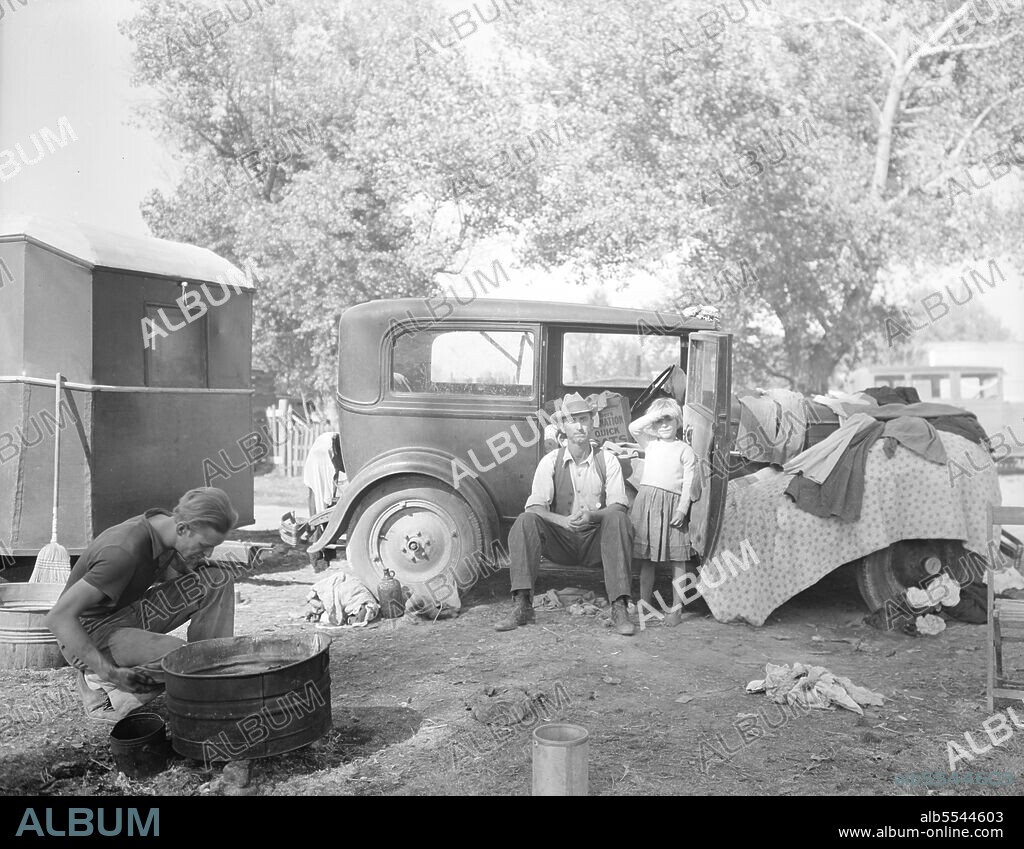DOROTHEA LANGE. Migratory family in auto camp. California.