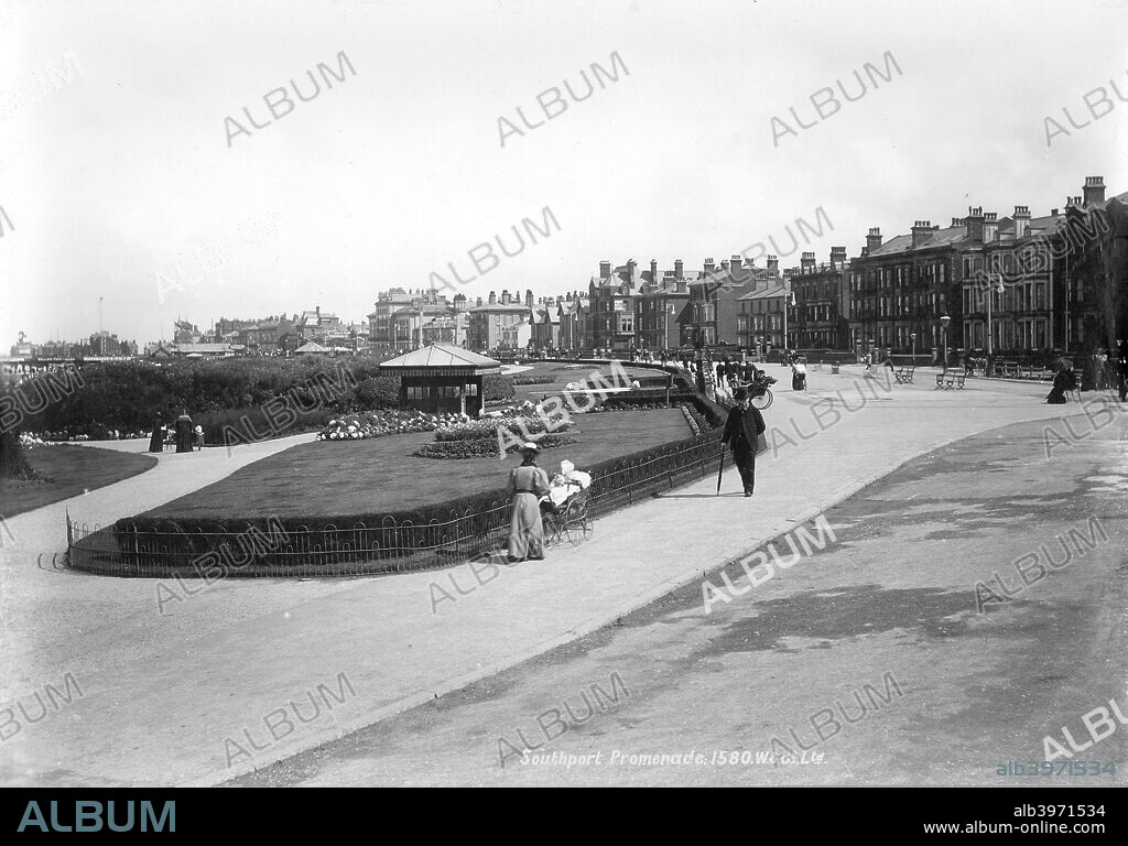 The Promenade, Southport, Lancashire, 1890-1910. The Southport Promenade was laid out in 1834 by Peter Hesketh Fleetwood. Here, pedestrians stroll past a landscaped garden.