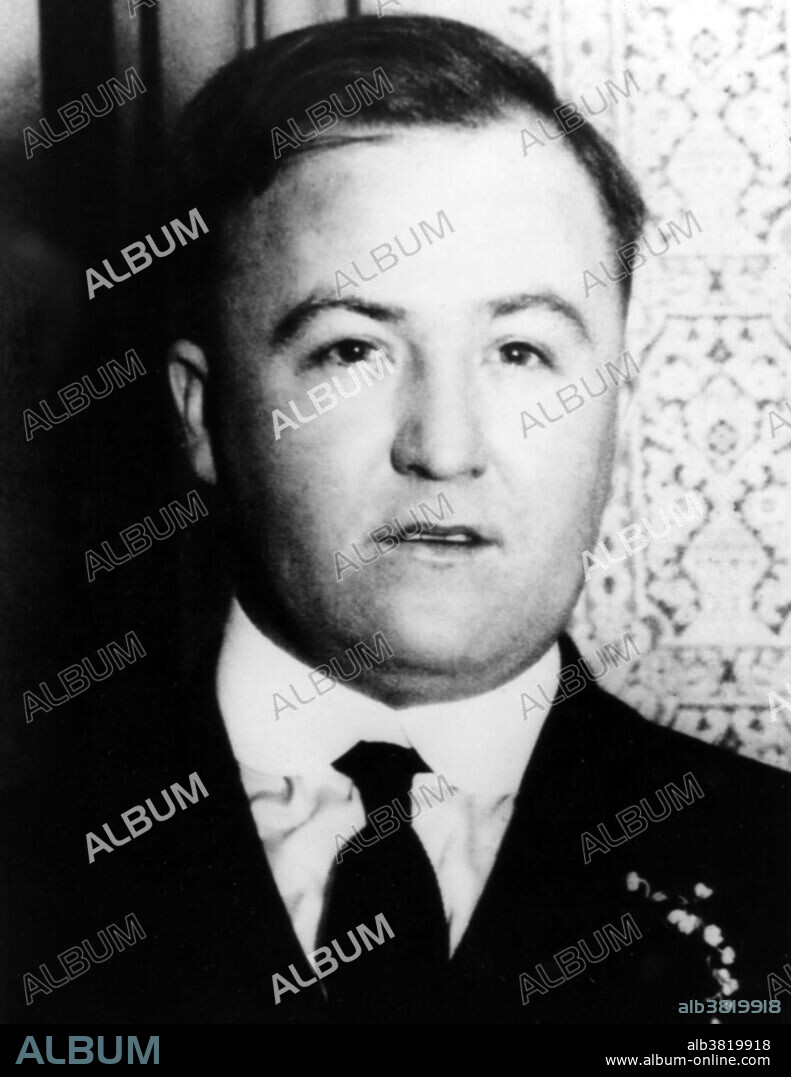 Charles Dean O'Banion (July 8, 1892 - November 10, 1924) was an Irish-American mobster. In 1920, O'Banion started a bootlegging operation. He arranged for beer suppliers in Canada to start shipments immediately, and struck deals with whiskey and gin distributors. He quickly eliminated all competition. The O'Banion mob, known as the North Side Gang, ruled the North Side and the Gold Coast, a wealthy area of Chicago. At the height of his power, O'Banion was supposedly making about $1 million a year on liquor. Torrio, the head of the Italian South Side mob, and his lieutenant, Al Capone, met with all the Chicago bootleggers to work out a system of territories. The North Siders now became part of a huge Chicago area bootlegging combine. He led the North Side Gang until 1924, when he was murdered. Two bullets were fired into his chest, two into his throat, and a final shot into the back of his head as he lay face down on the floor. He was 32 years old. No photographer credited, undated.