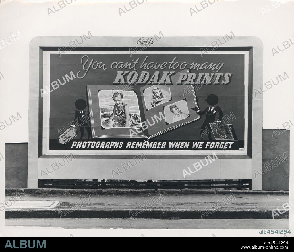Photograph, Billboard, 'You Can't Have Too Many Kodak Prints: Photographs Remember When We Forget', Sydney, circa 1950s, Black and white photograph of a large promotional Kodak billboard with the slogan 'You Can't Have Too Many Kodak Prints' and 'Photographs Remember When We Forget', with an image of a large photo album held by two cartoon men, one holding a film carton and the other a book of Kodak prints. The billboard, leased by Roffs, an advertising company, was likely posted in Sydney, circa 1950s.