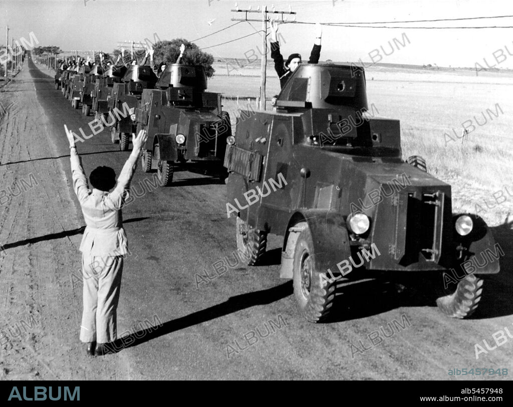 Beginning Of The Evacuation of Torquay Camp, which has been abandoned by the Defense Department. Top: The armored car section, which left first. Col. Ainsworth, the Commander, is halting the column to give final instructions. Lower: Sergt. H.R. Bodman, of Yarram, a member of the 13th Light Horse, with his kit. April 22, 1940.