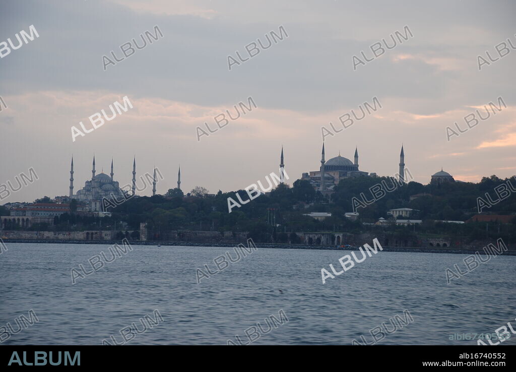 Skyline of Istanbul, Turkey, at dawn seen from the Bosporus with the Hagia Sophia and the Blue Mosque (left).