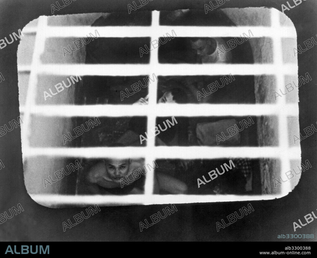 Con Son Island, South Vietnam:  July, 1970.South Vietnamese political prisoners peering up from a "tiger cage" cell in a prison off the South Vietnam coast. The photograph was taken by Tom Harkin, an aide on a U.S. Congressional visit to the prison. Harkin later became an Iowa Senator.