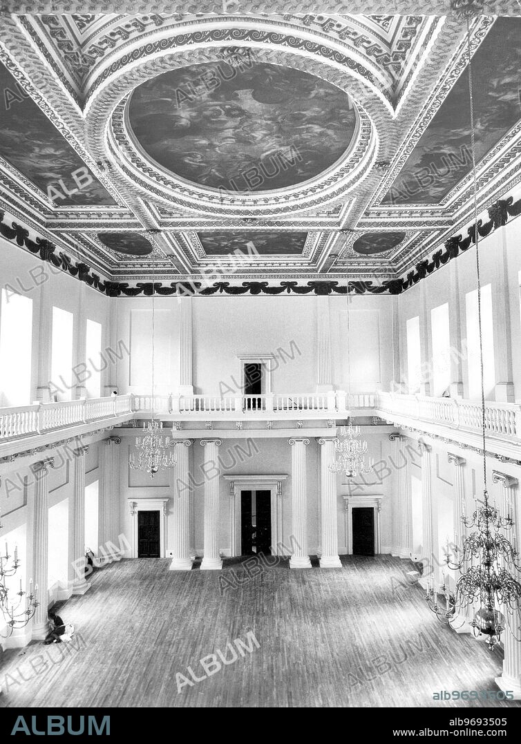 Inigo Jones Banqueting House as Receptions Centre for Whitehall, 22nd September 1964. The Banqueting House in Whitehall, built by Inigo Jones between 1619 and 1622, has been restored almost to its original condition. To mark the occasion, the Minister of Public Building and Works, Mr G Rippon, MP, is to hold a reception there this evening and the building will be open to the public from 10 am the following day. Besides being open to the public, it is intended to use the Banqueting House on occasions for Government receptions and as a hall where concerts of a non-profit-making nature can be held. The Banqueting House is the only important part of Whitehall Palace that escaped the fire of 1698. Since Victorian Times the building has been used by the Royal United Service Institution as a museum for military relics. The beauty of the hall, with a gallery all round and a ceiling of nine panels painted by Rubens, will be more widely enjoyed. The £40,000 restoration scheme has been carried out by the Ministry of Public Building. Various alterations made to accommodate the Museum exhibits have been removed and the hall restored as far as possible to the original design. Photo Shows: A view from the Gallery looking towards the main doors. The ceiling consists of magnificent panels by Rubens.